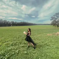 Haley of My Moon Girl Readings standing in a field.